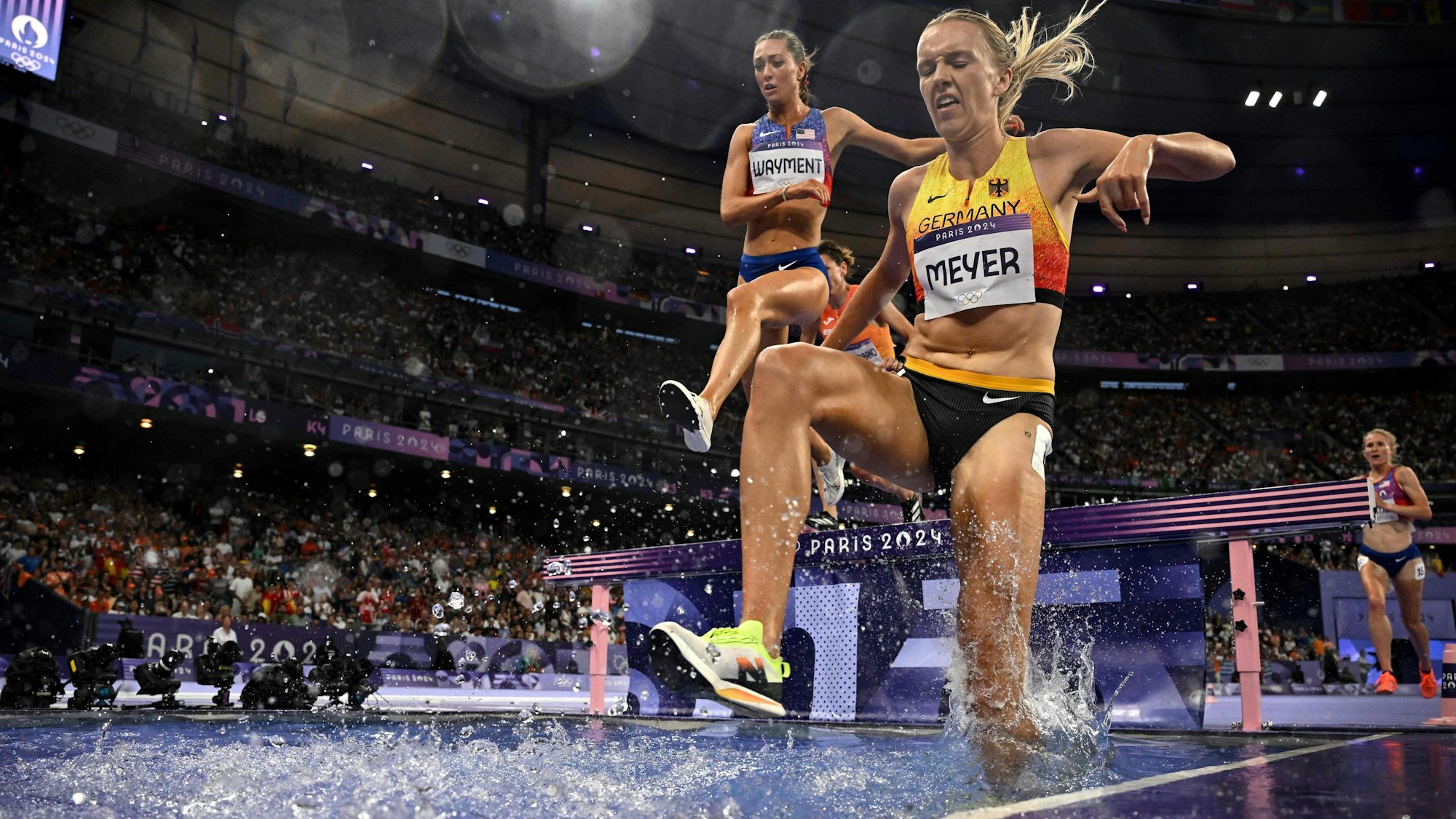 US' Courtney Wayment (L) and Germany's Lea Meyer compete in the women's 3000m steeplechase final of the athletics event at the Paris 2024 Olympic Games at Stade de France in Saint-Denis, north of Paris, on August 6, 2024. (Photo by Ben STANSALL / AFP)
