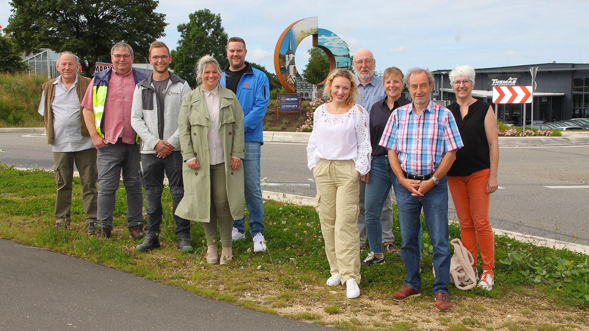 Vertreter der Verwaltung, der beauftragten Firmen stehen vor dem neuen Kunstwerk.