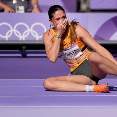 Sophie Weissenberg, of Germany, grabs her ankle after being injured while warming up for the women's heptathlon 100-meter hurdles at the 2024 Summer Olympics, Thursday, Aug. 8, 2024, in Saint-Denis, France.(AP Photo/Ashley Landis)
