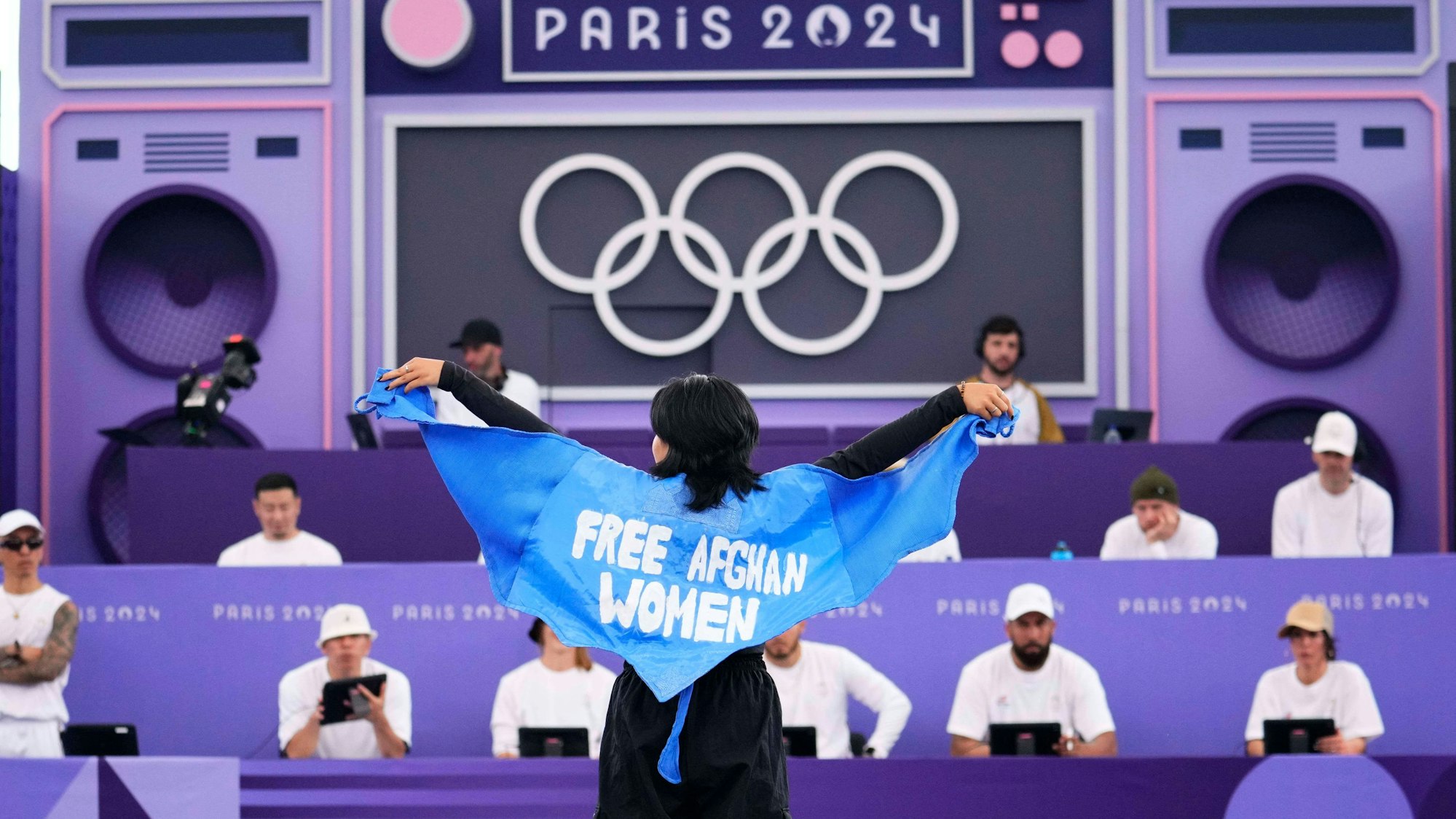 Talash mit dem hellblauen Umhang, der die Aufschrift „Free Afghan Women“ trägt.