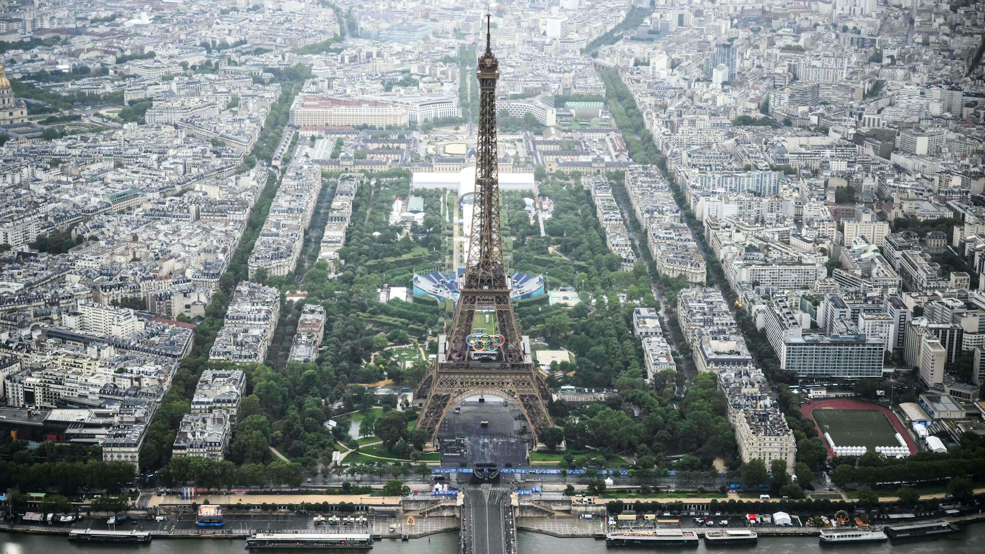 TOPSHOT - A photograph taken from an helicopter on July 26, 2024 shows an aerial view of Eiffel Tower during the opening ceremony of the Paris 2024 Olympic Games in Paris. (Photo by Lionel BONAVENTURE / POOL / AFP)