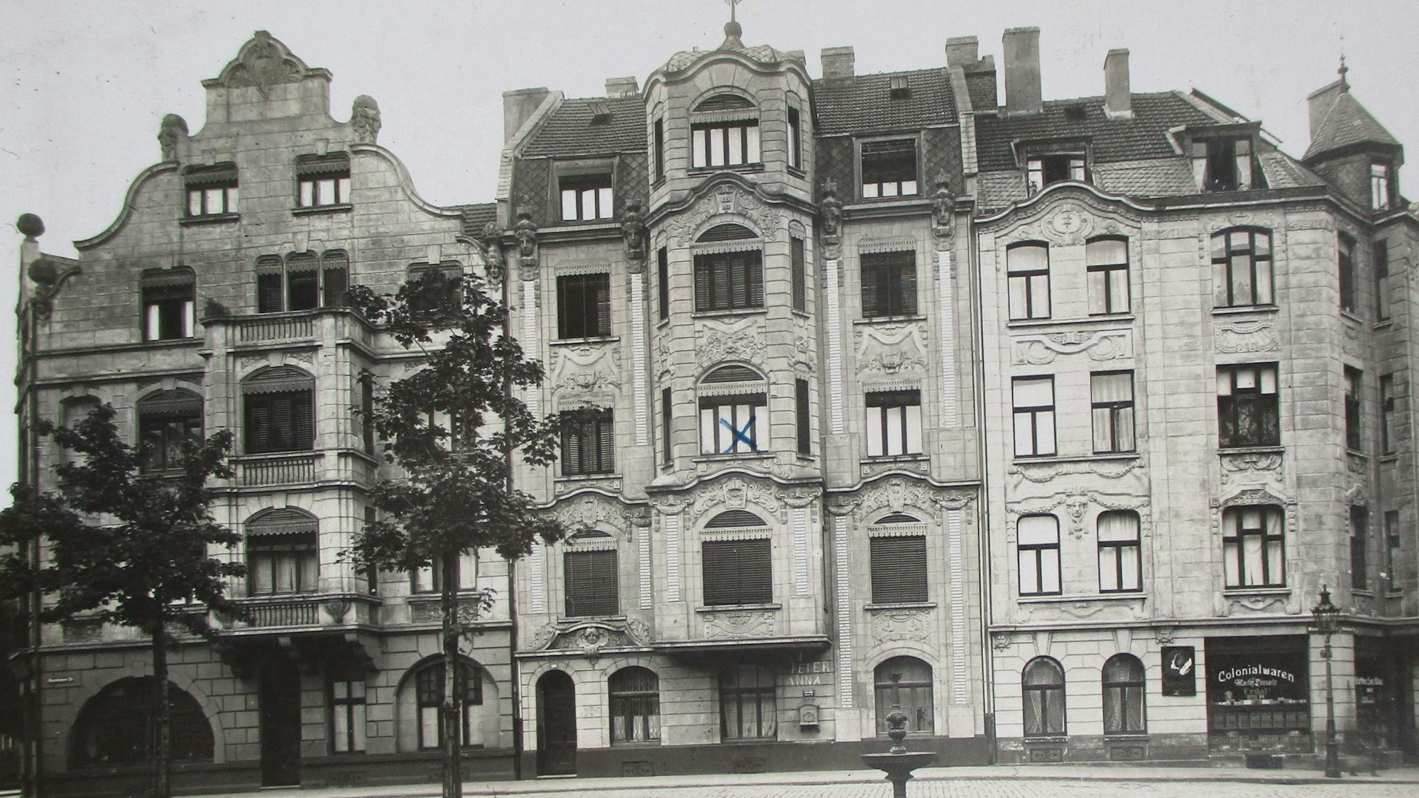Zu sehen sind drei Jugendstil-Gebäude auf einer Schwarz-Weiß-Fotografie.