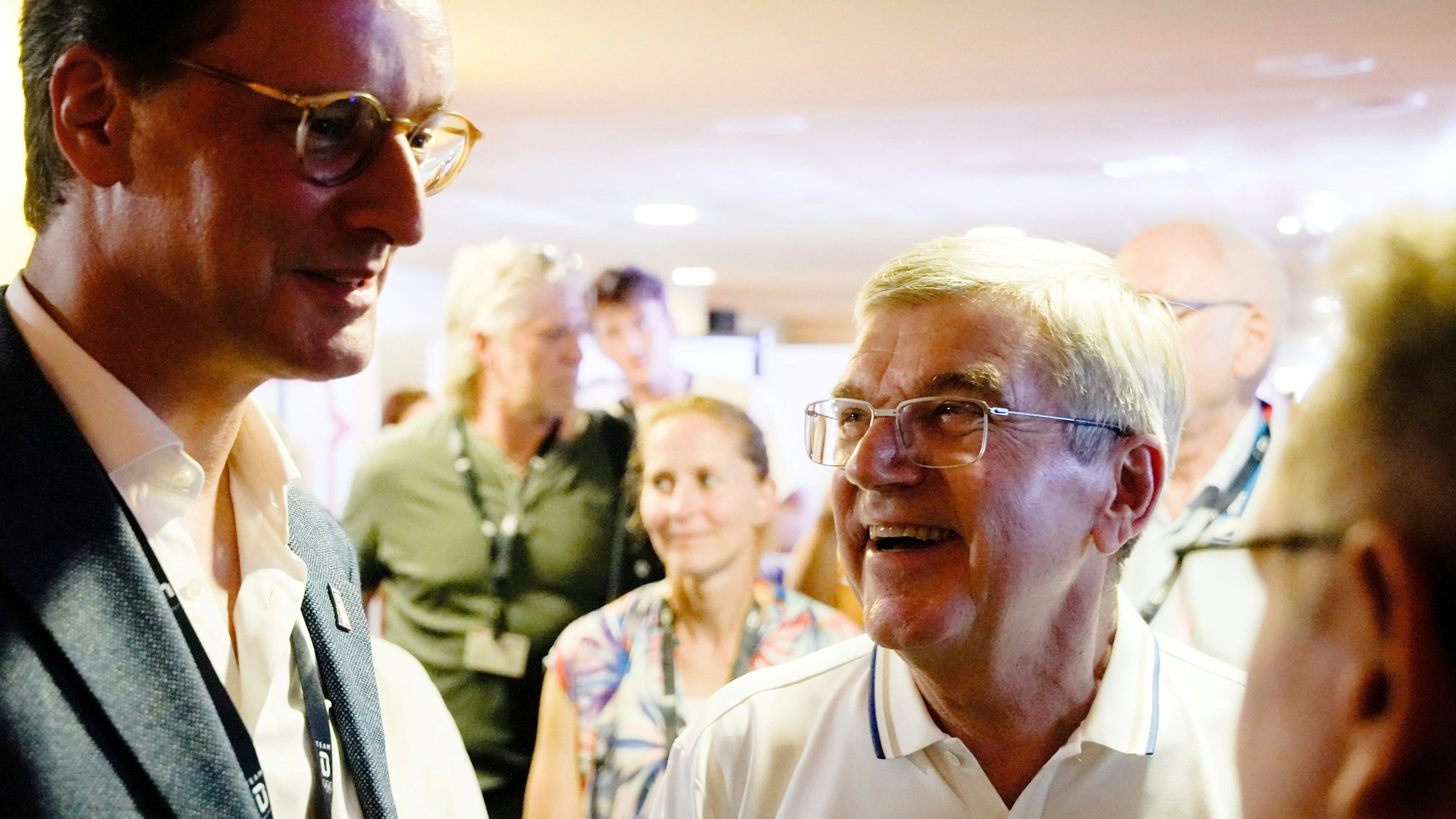 NRW-Ministerpräsident Hendrik Wüst und IOC-Präsident Thomas Bach unterhalten am sich NRW-Abend im Deutschen Haus.