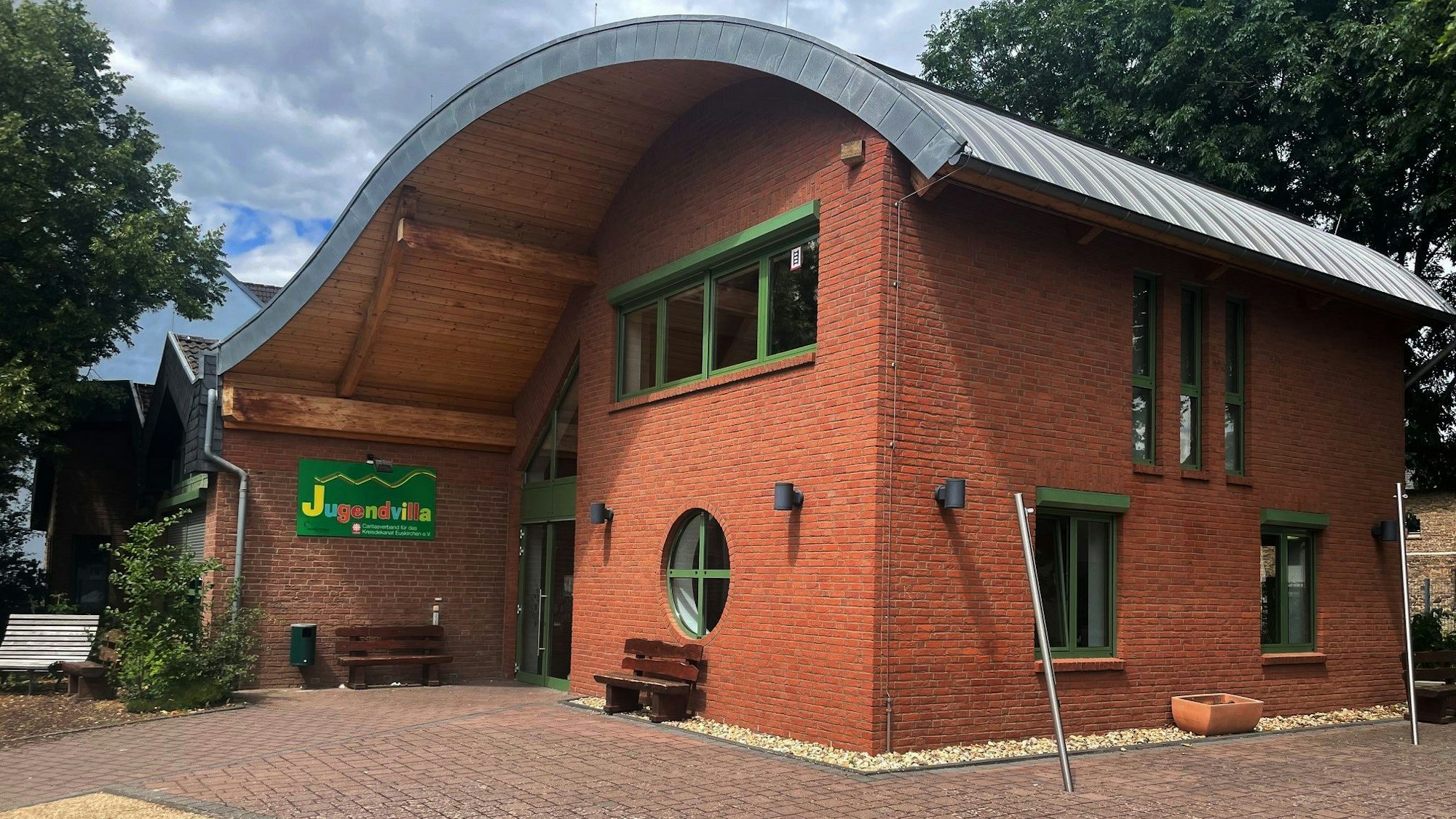 Ein Backsteingebäude trägt ein Schild mit der Aufschrift „Jugendvilla“.