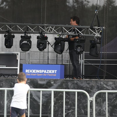 Eine leere Bühne, davor Kinder am Absperrgitter