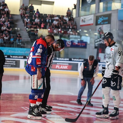 Haie-Kapitän Moritz Müller (r.) begutachtet das Loch im Eis; die Testpartie musste abgebrochen werden.