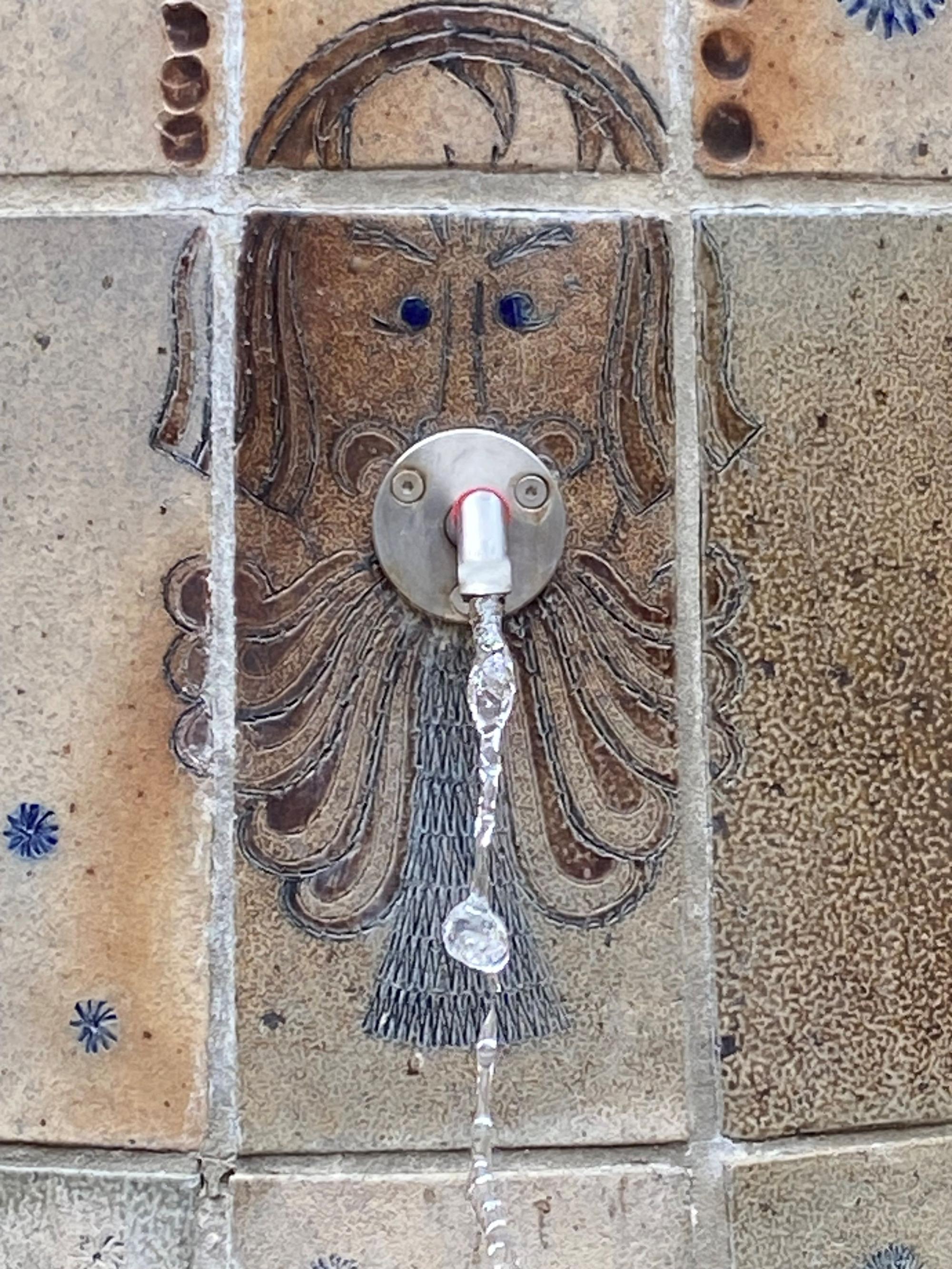 Auf dem Bild ist ein Detail des Rathausbrunnens zu sehen, ein Bartmann dient als Wasserspeier.