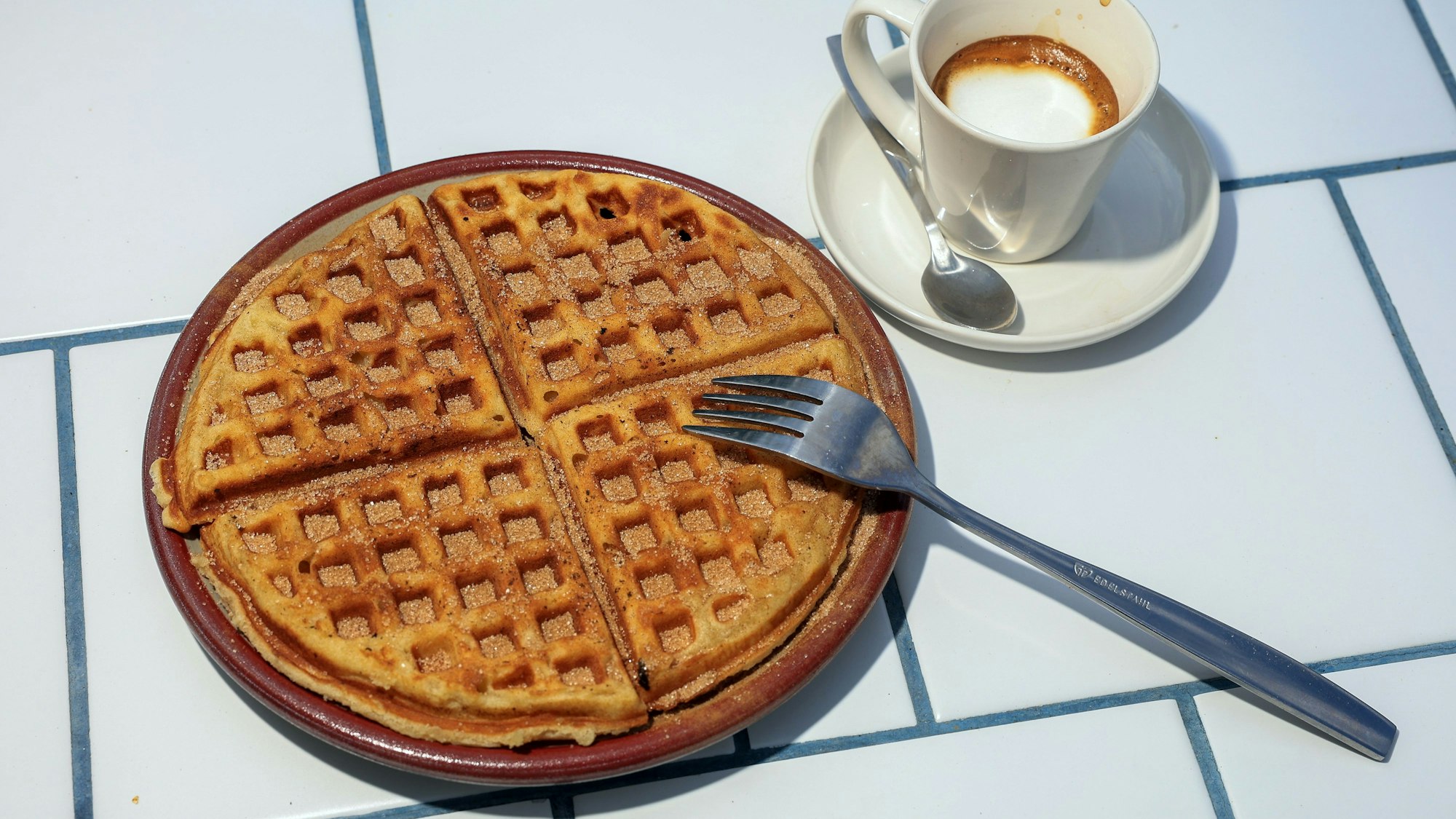 Espresso Macchiato und eine Waffel sind im Bild zusehen.