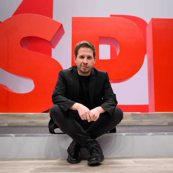 Kevin Kühnert, SPD-Generalsekretär, sitzt im Vorfeld des ordentlichen Bundesparteitags der SPD bei einem Hallenrundgang durch den Tagungsort vor einem SPD-Logo. (Archivbild)
