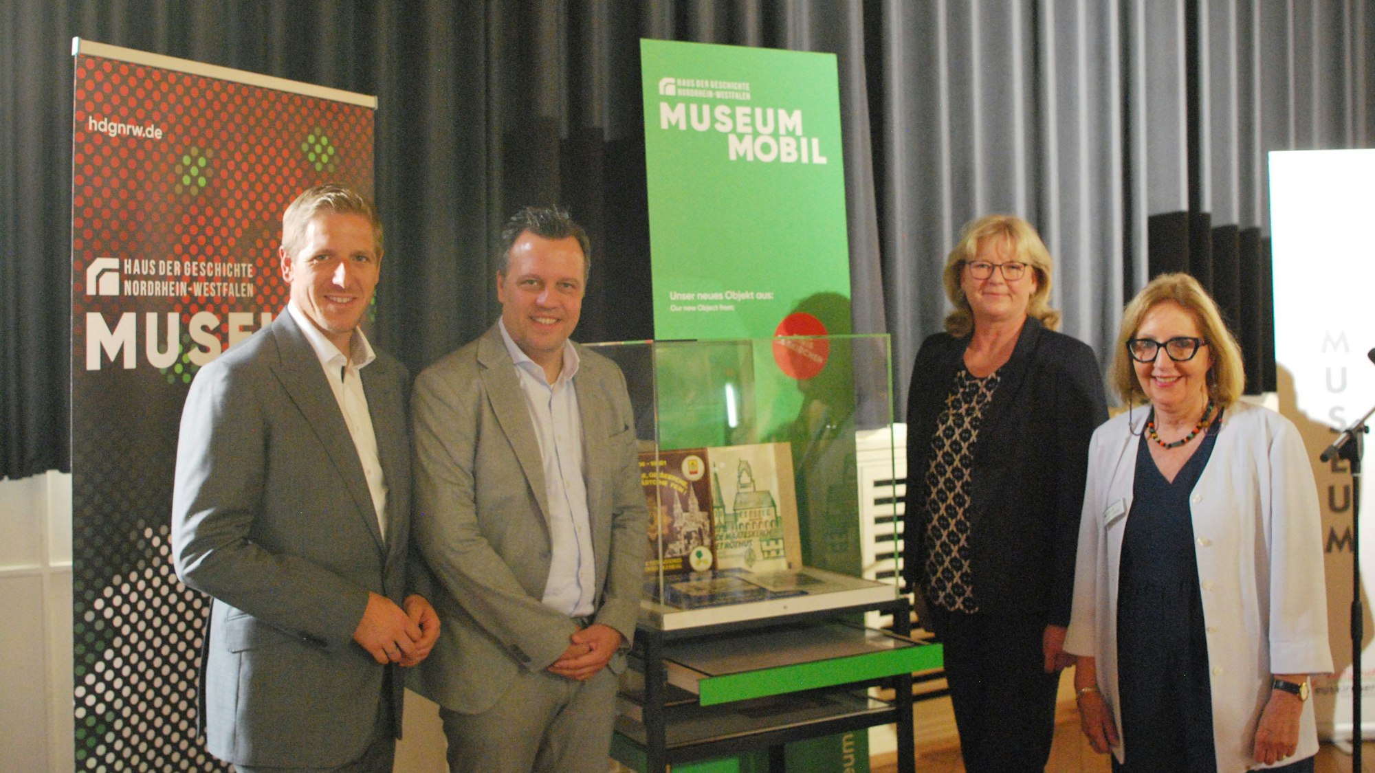 Ramers, Reichelt, Uelsberg und Lützenkirchen flankieren eine Vitrine mit den Schallplatten, die die Stadt dem Land für seine Museumssammlung überlässt.