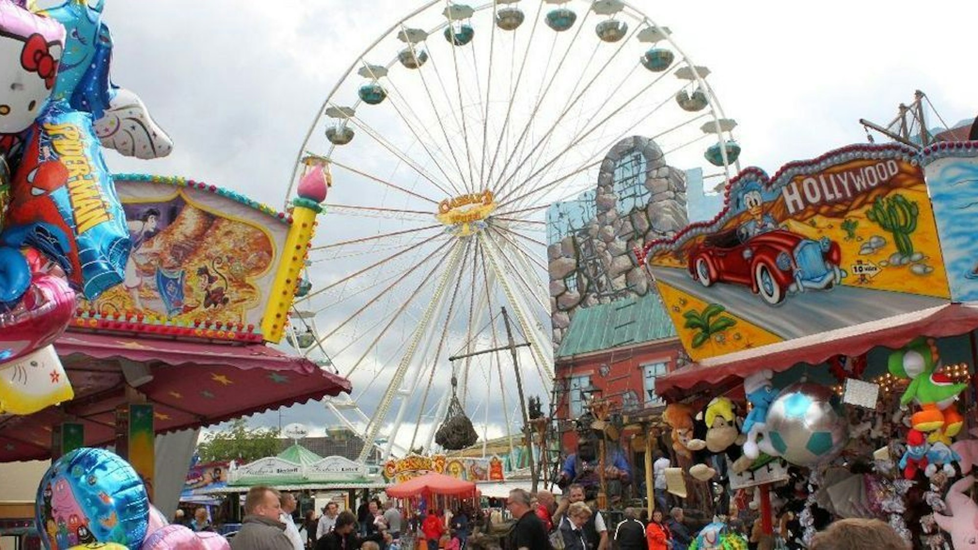 Ein Riesenrad ragt über Buden der Wermelskirchener Kirmes.