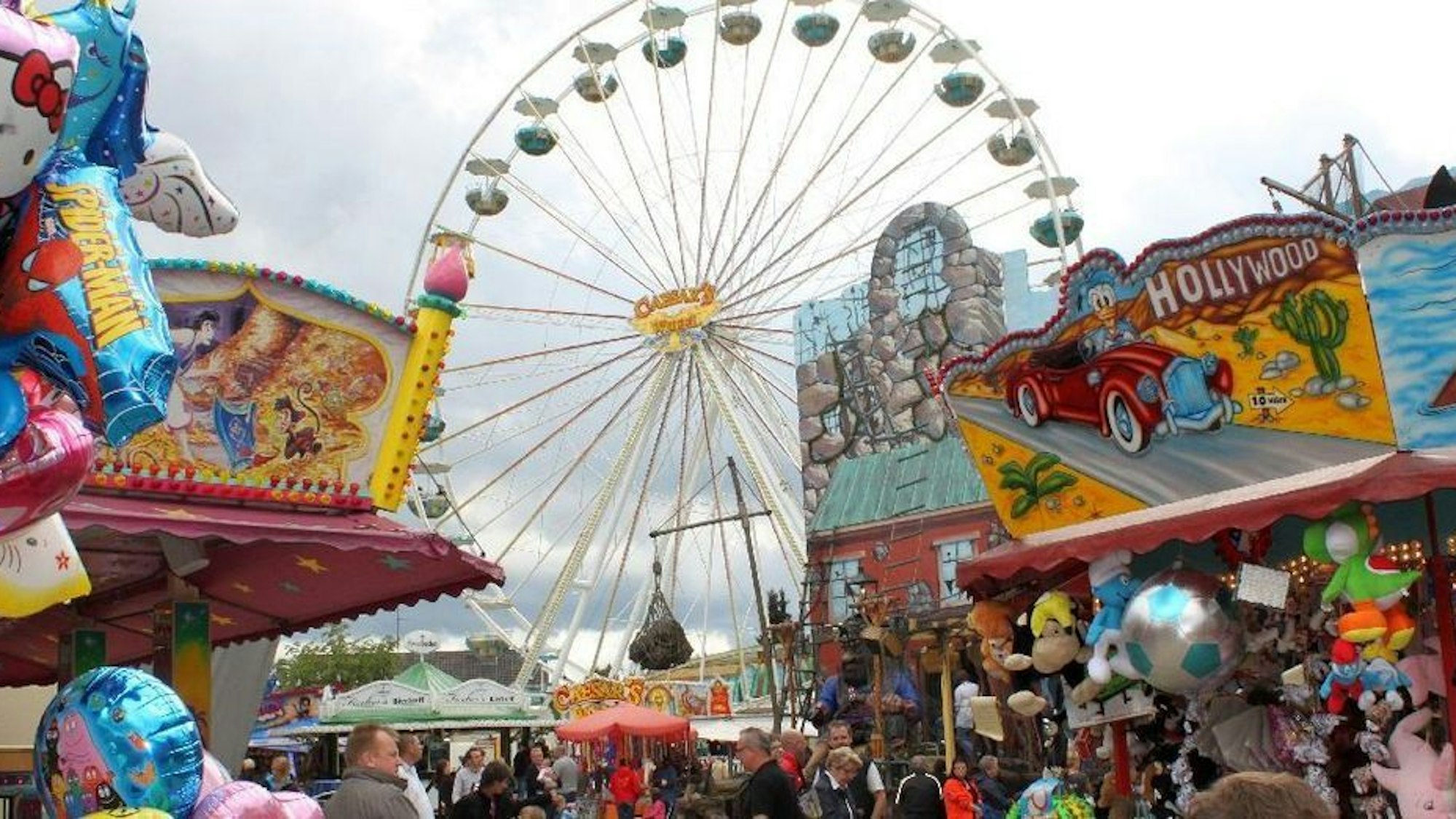 Ein Riesenrad ragt über Buden der Wermelskirchener Kirmes.