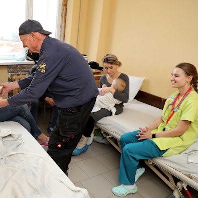 Norbert Kuhl von der Humanitären Hilfe Overath übergibt einem Kind in der Kindeklinik Lviv ein Geschenk.