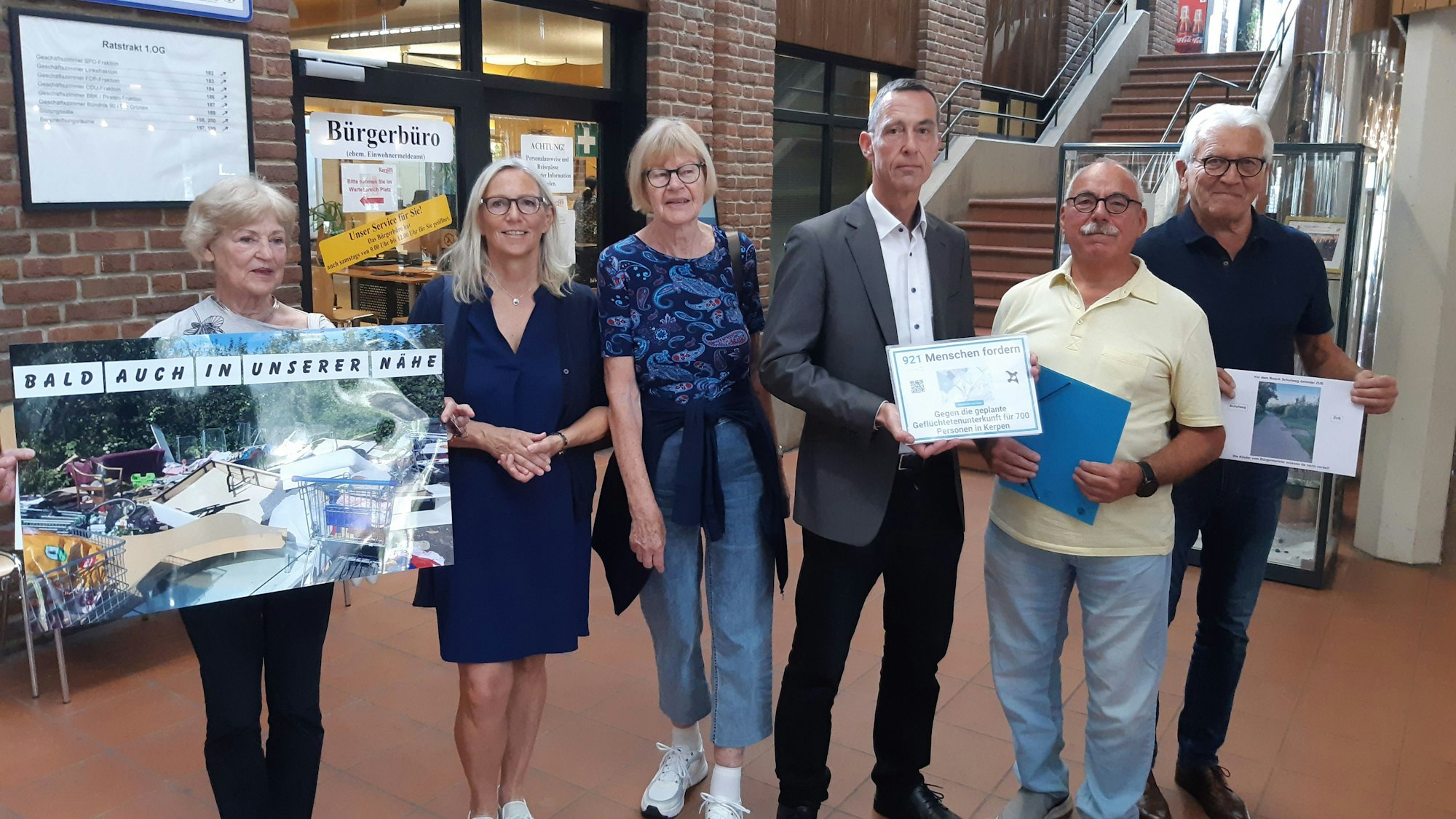 Auf dem Bild sind einige besorgte Bürgerinnen und Bürger zu sehen, die ihre Petition dem Kerpener Bürgermeister Dieter Spürck übergeben.
