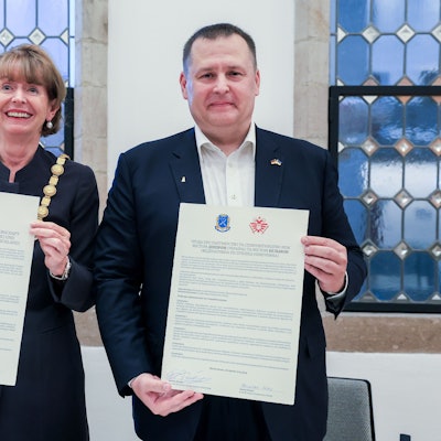 Zu sehen ist Henriette Reker mit Dnipros Bürgermeister Boris Filatov, die Urkunden in den Hälten halten, in der Vorderansicht.