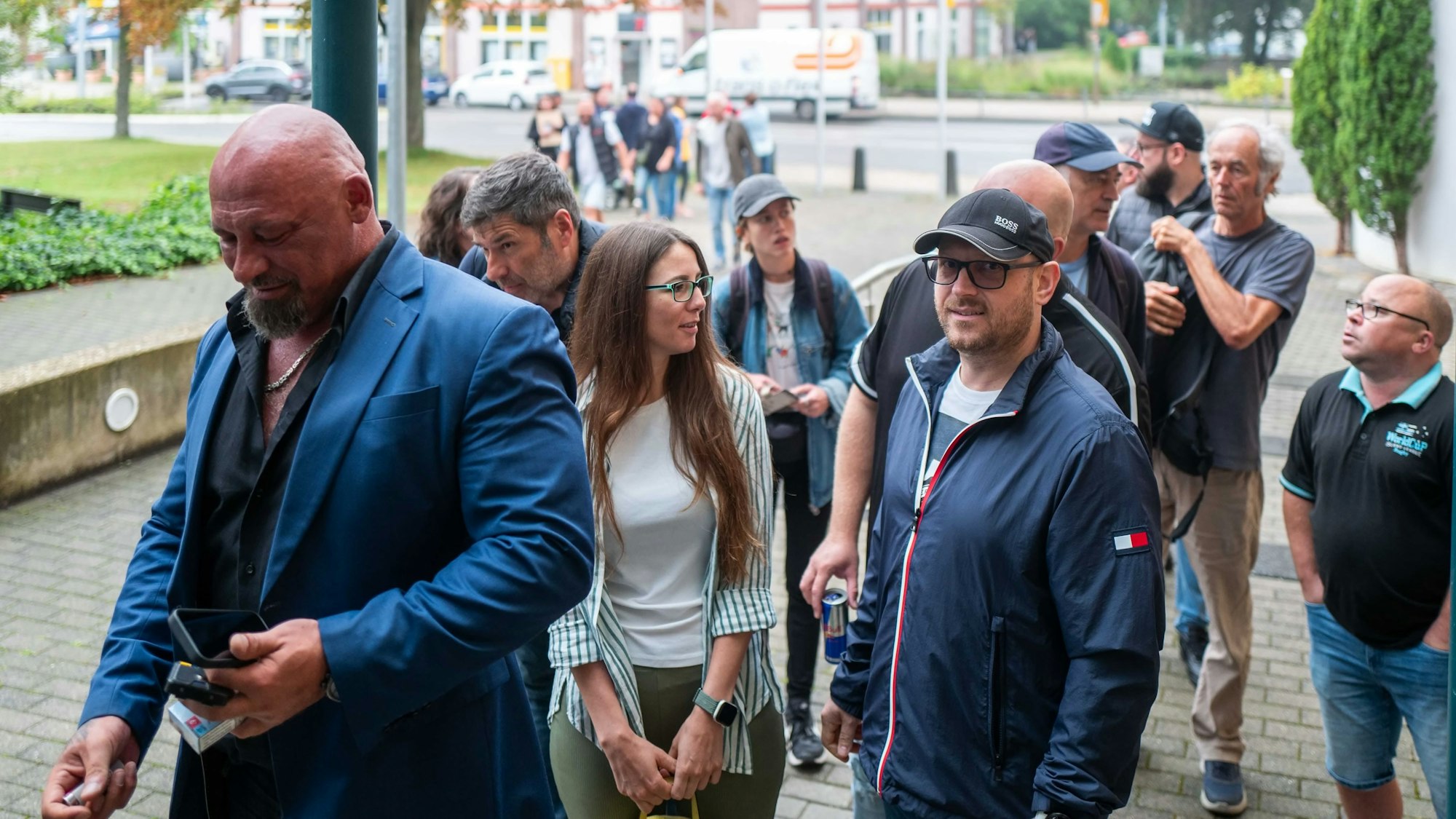 Das Bild zeigt Michael Betke, wie er ins Gericht geht. Im Hintergrund sind Arbeitskollegen zu sehen.