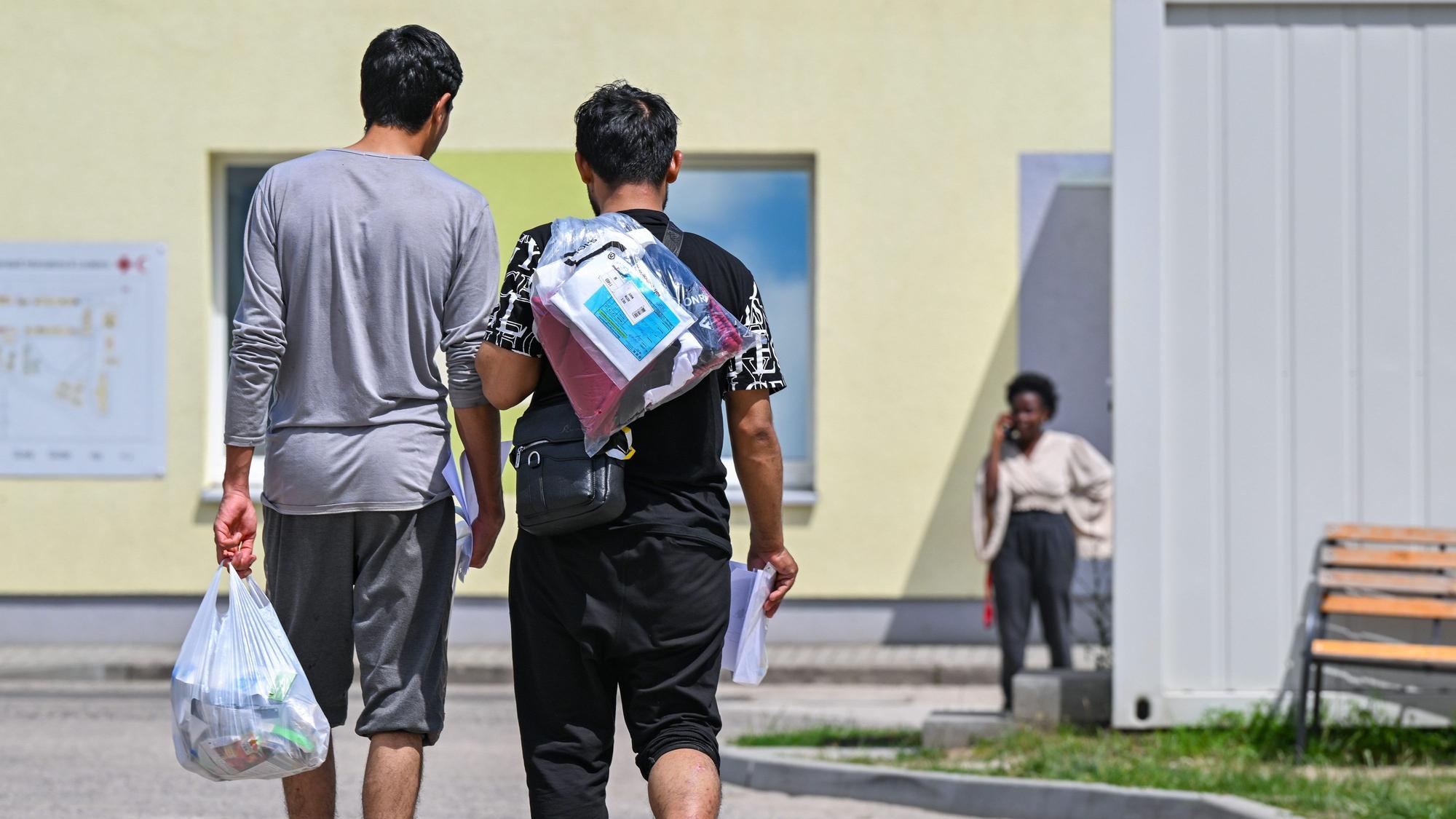 Zwei Migranten gehen über das Gelände der Zentralen Erstaufnahmeeinrichtung für Asylbewerber.