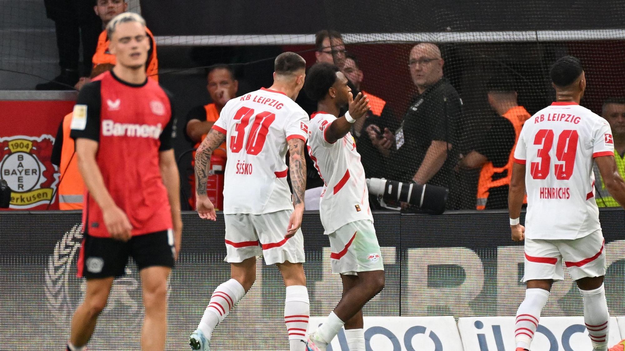 Lois Openda jubelt über das Tor zum 2:2 gegen Bayer Leverkusen und Florian Wirtz (l.).