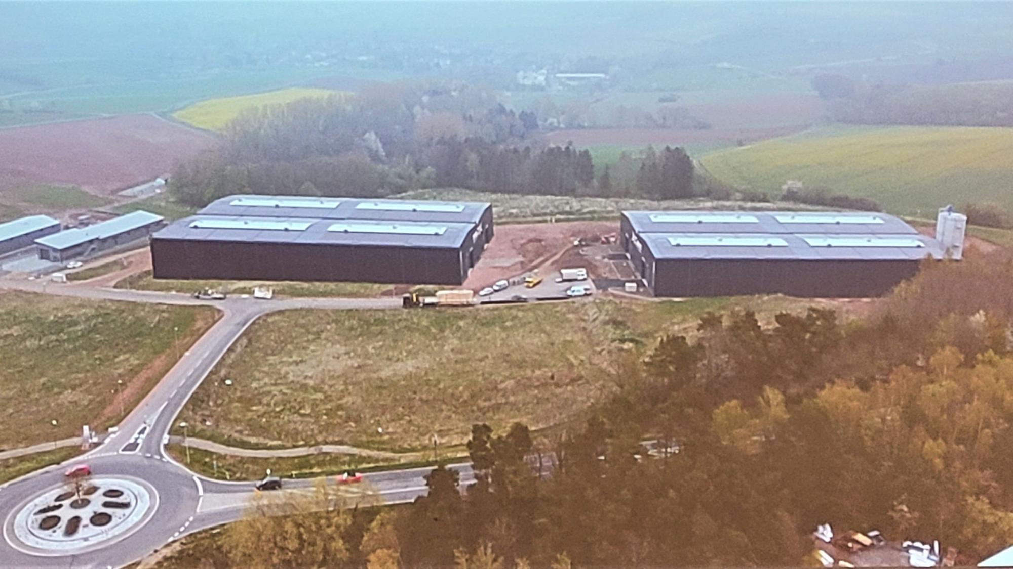 Die Visualisierung zeigt die beiden gleich großen Hallen und einen Kreisverkehr.