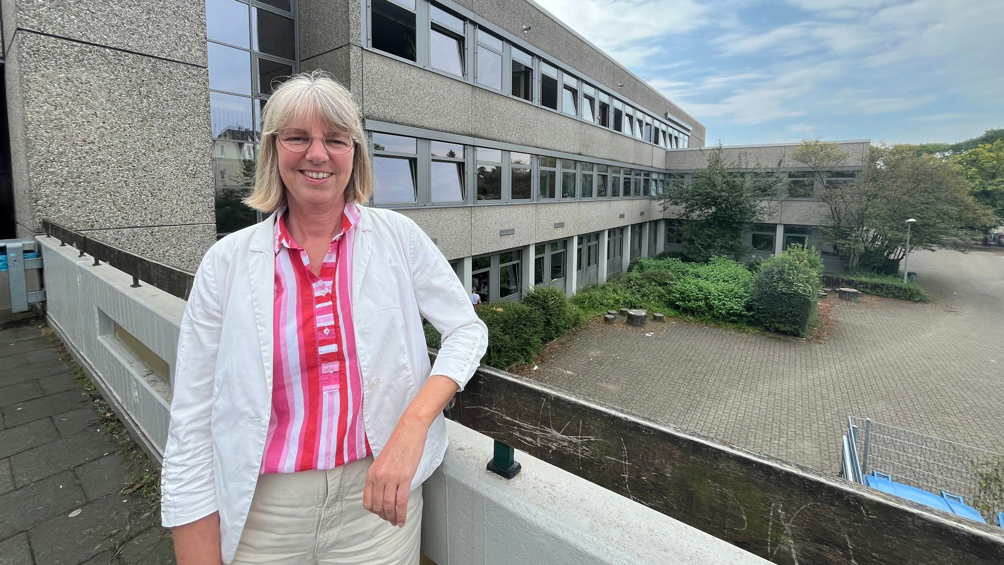 Frau vor Schulgebäude