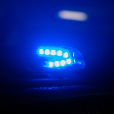 Blaulicht leuchtet auf dem Dach eines Polizeiautos.
