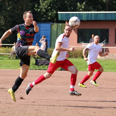 Ein Fußballer schießt per Heber aufs Tor.