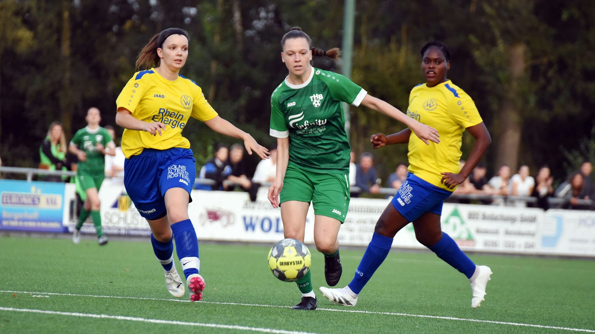 Eine Spielsituation mehrere Frauen auf einem Fußballplatz.