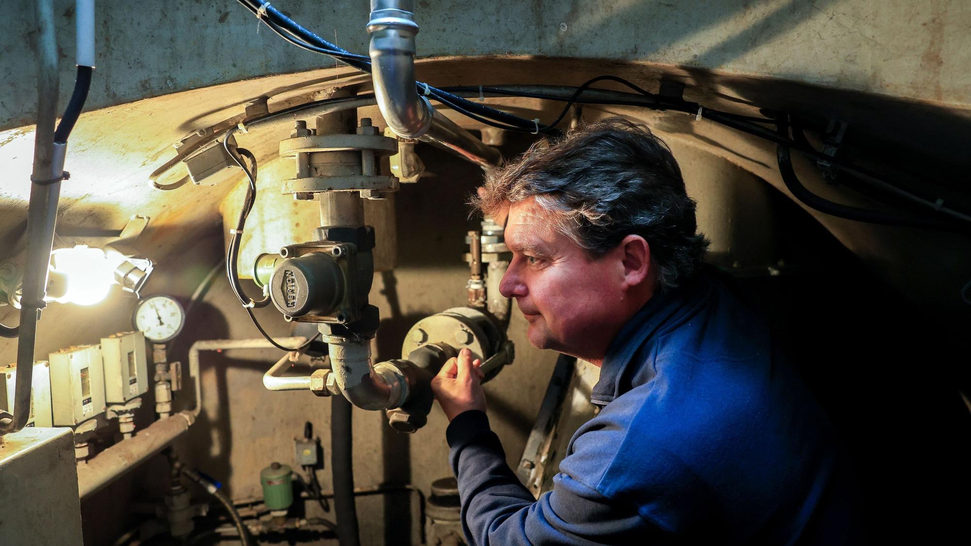 Guido Rahm in einem Bunker mit technischer Ausstattung im Hintergrund.