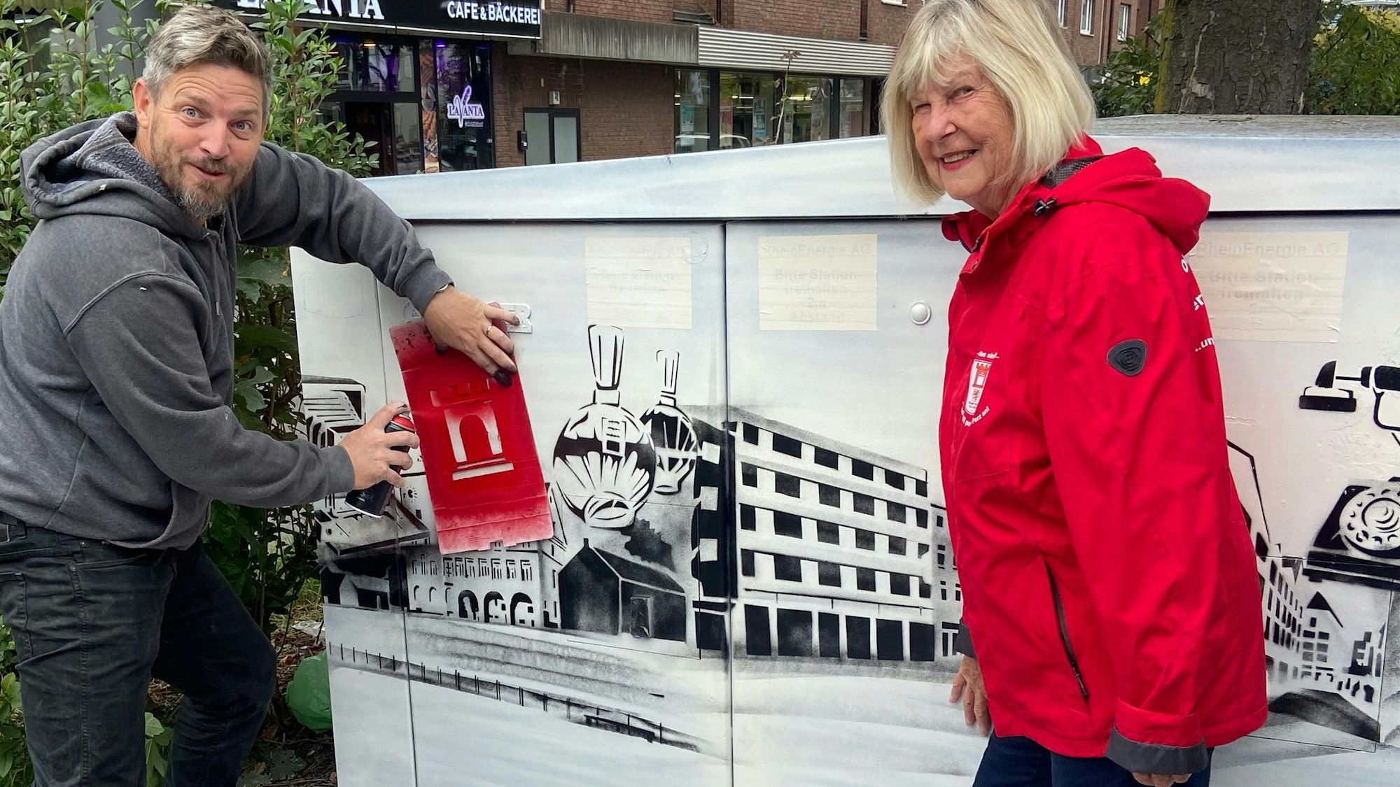 Marc Jungmann sprayt Ansichten aus Porz und Motive von hier Tätigen Unternehmen auf Verteilerkästen.