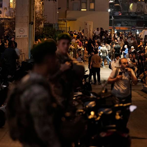 People gather outside the American University hospital after the arrival of several people who were wounded by exploding handheld pagers, in Beirut, Lebanon, Tuesday, Sept. 17, 2024. (AP Photo/Hassan Ammar)
