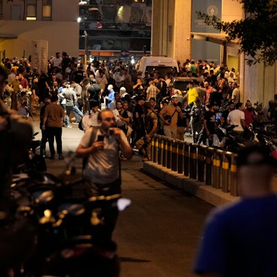 People gather outside the American University hospital after the arrival of several people who were wounded by exploding handheld pagers, in Beirut, Lebanon, Tuesday, Sept. 17, 2024. (AP Photo/Hassan Ammar)