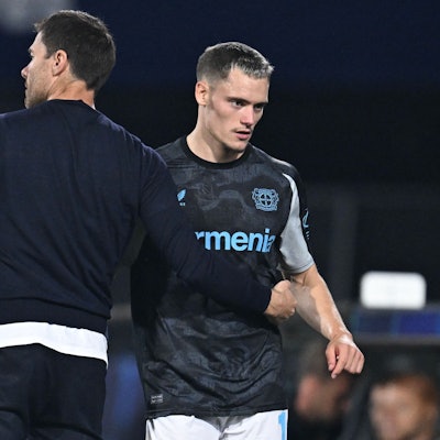Bayer Leverkusen's Spanish coach Xabi Alonso (L) speaks with Bayer Leverkusen's German midfielder #10 Florian Wirtz (R) on the sidelines during the UEFA Champions League 1st round day 1 football match between Feyenoord and Bayer Leverkusen at The De Kuip Stadium, in Rotterdam on September 19, 2024. (Photo by JOHN THYS / AFP)