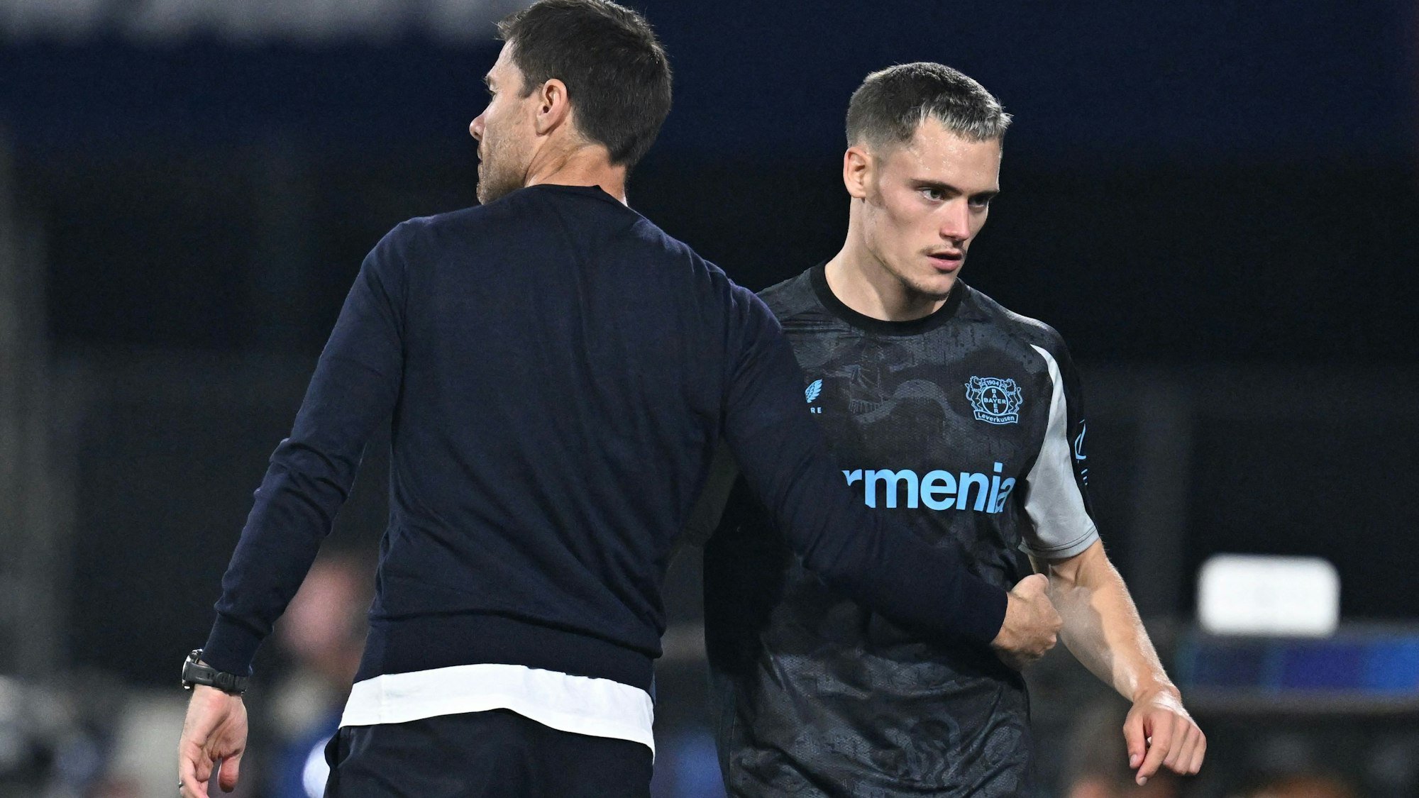 Bayer Leverkusen's Spanish coach Xabi Alonso (L) speaks with Bayer Leverkusen's German midfielder #10 Florian Wirtz (R) on the sidelines during the UEFA Champions League 1st round day 1 football match between Feyenoord and Bayer Leverkusen at The De Kuip Stadium, in Rotterdam on September 19, 2024. (Photo by JOHN THYS / AFP)