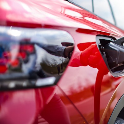 Ein rotes E-Auto wird aufgeladen.