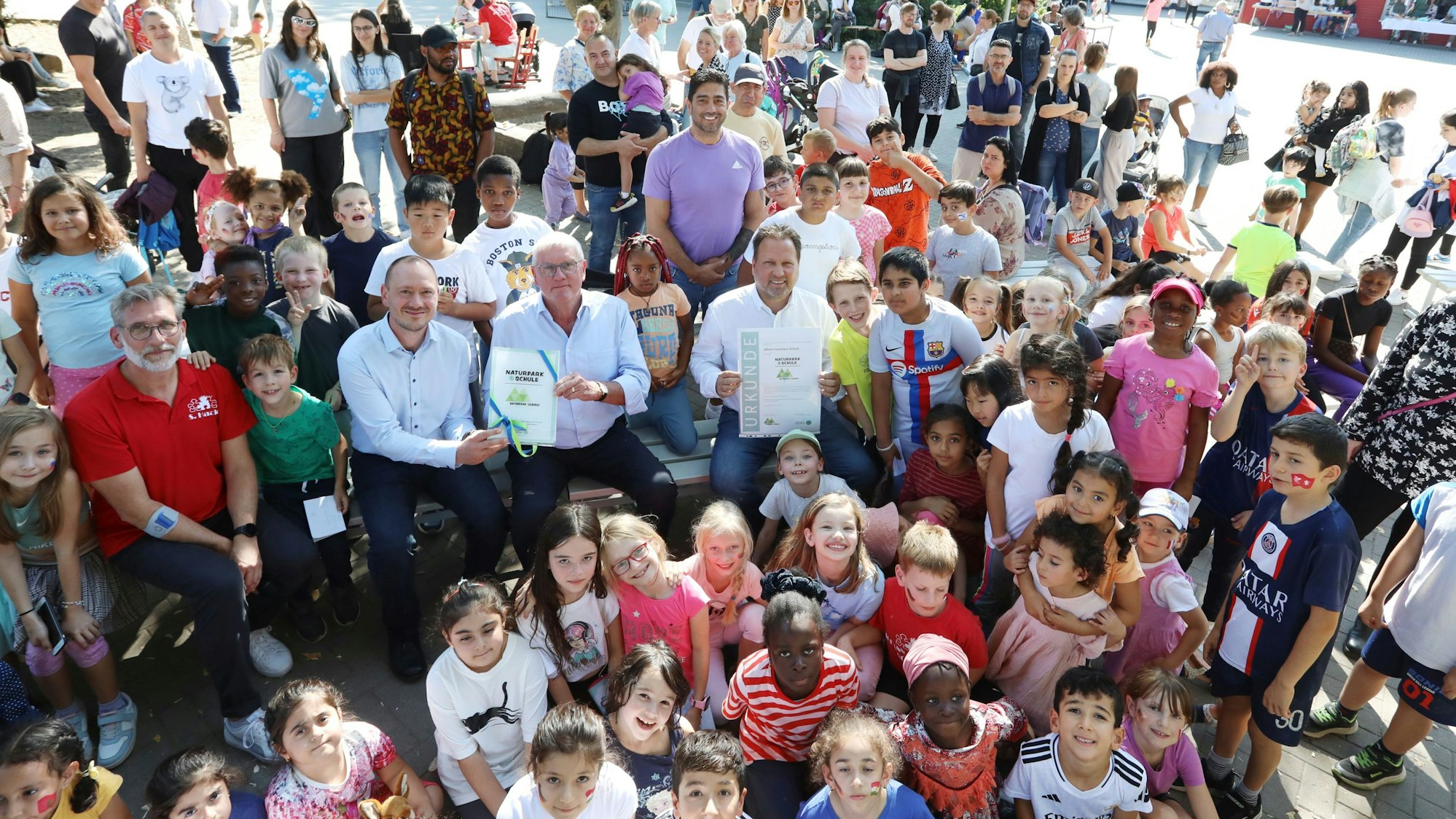 Eine große Gruppe von Kindern und mittendrin einige Erwachsene