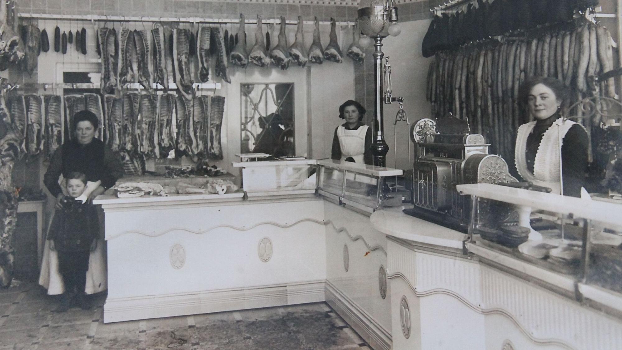 Schwarzweißfoto des Verkaufsraums einer Metzgerei von 1915