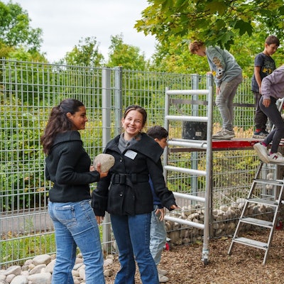 Schüler der Freien Naturschule Köln befüllen den ersten Abschnitt von Kölns größtem Insektenhotels mit Steinen.
