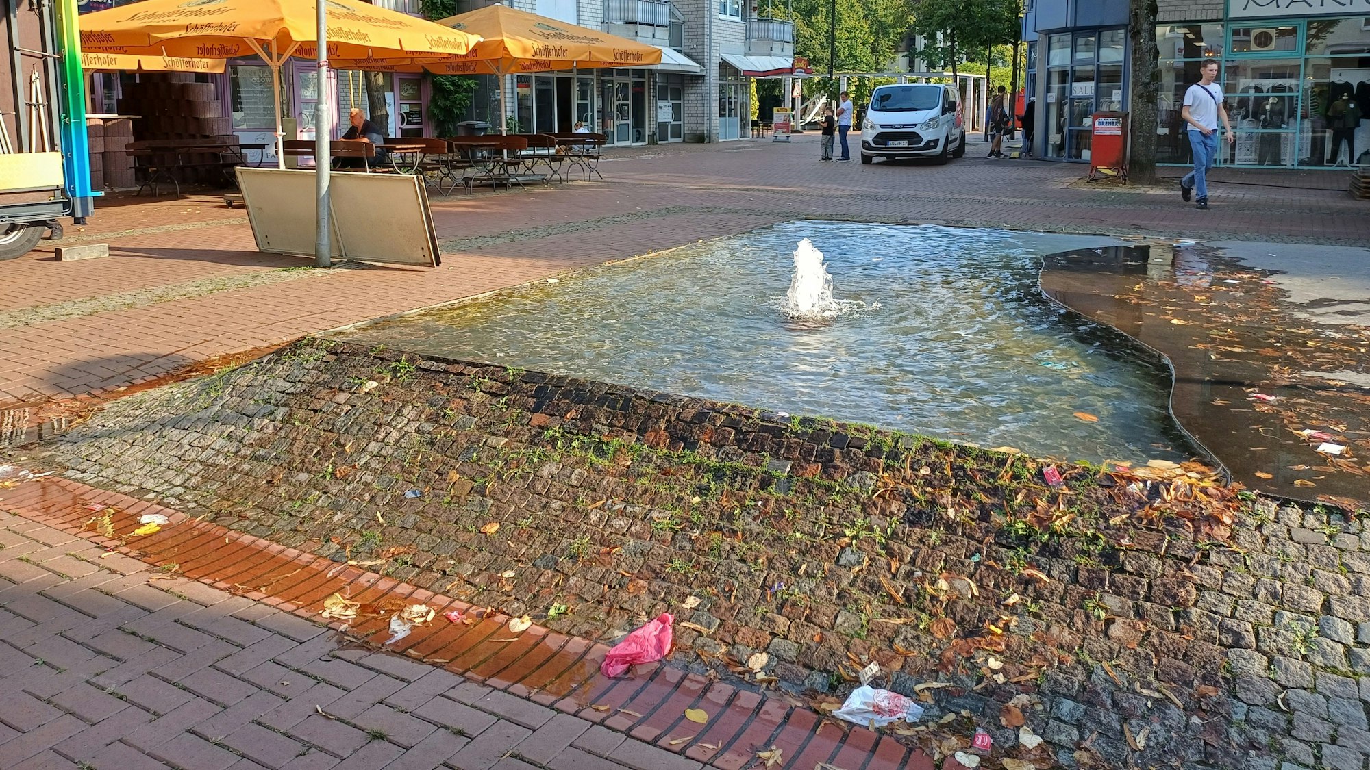 Ein Brunnen sprudelt auf einem Platz.