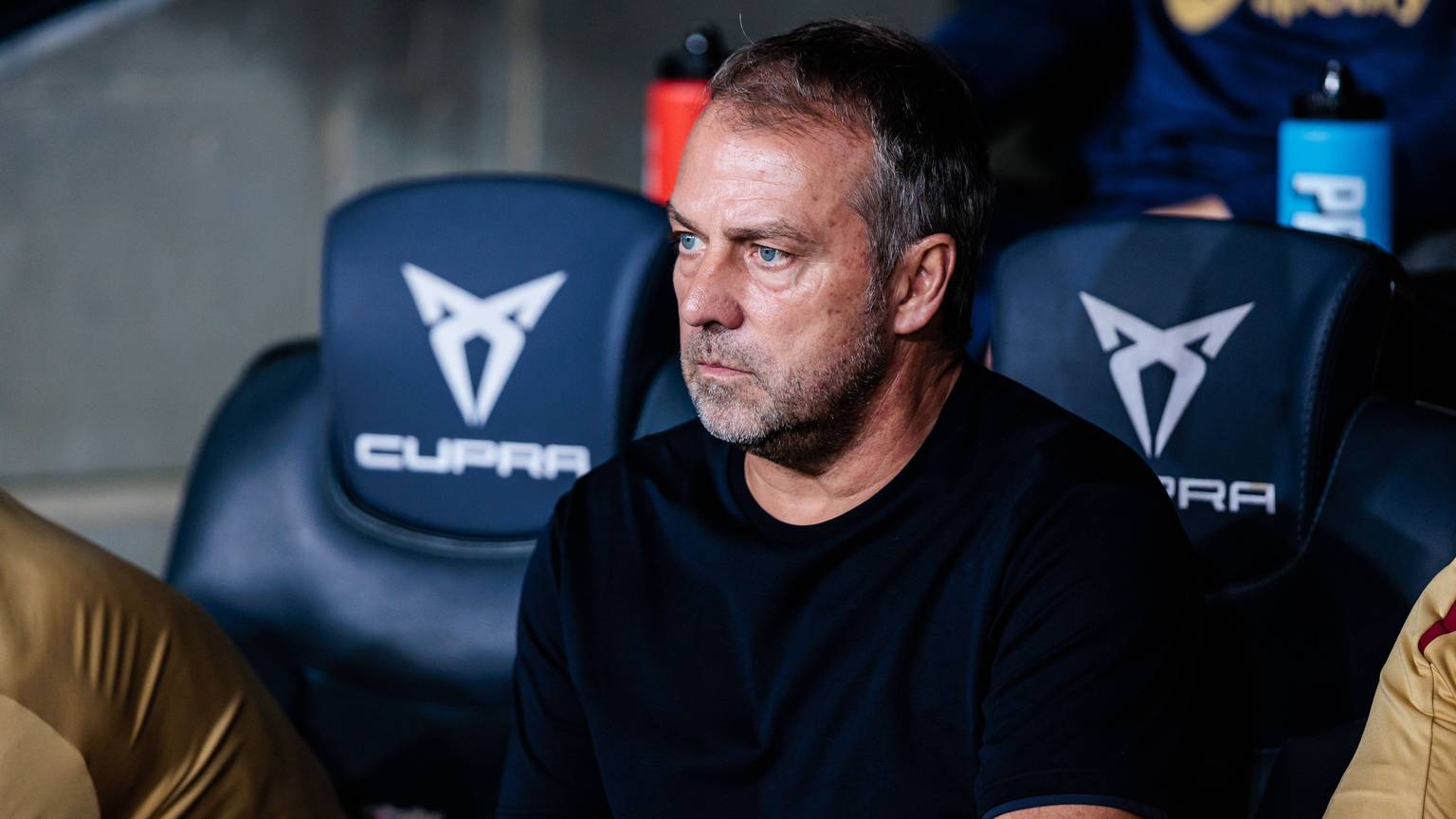 Barca-Trainer Hansi Flick sitzt während einer Partie an der Seitenlinie. Auf einem Banner mit Bezug zum Nationalsozialismus hatte sein Name gestanden. Die Aktion hat nun Folgen.