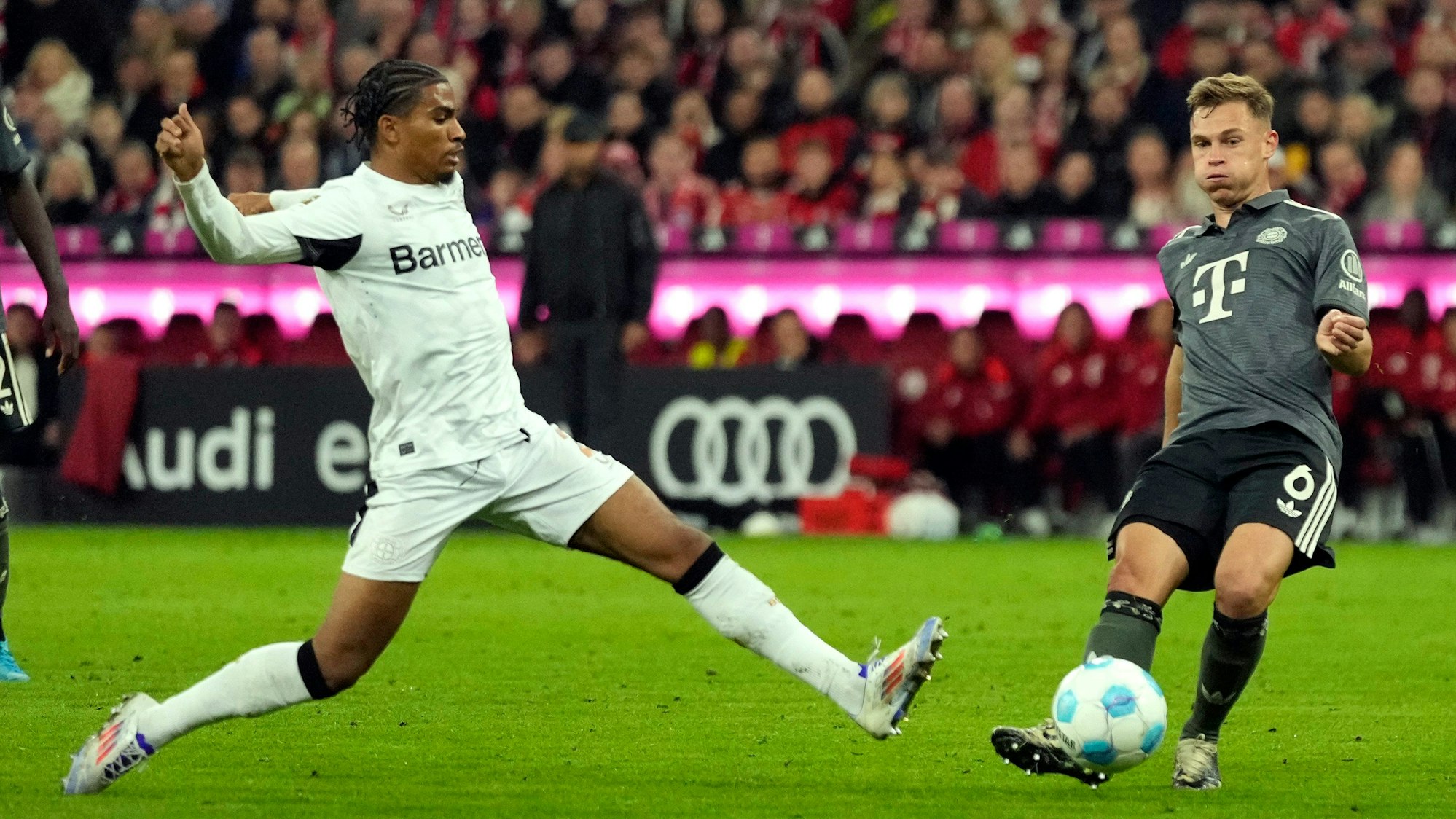 Leverkusen's Amine Adli, left, and Bayern's Joshua Kimmich vie for the ball during the Bundesliga soccer match between Bayern Munich and Leverkusen at the Allianz Arena in Munich, Germany, Saturday, Sept. 28, 2024. (AP Photo/Matthias Schrader)