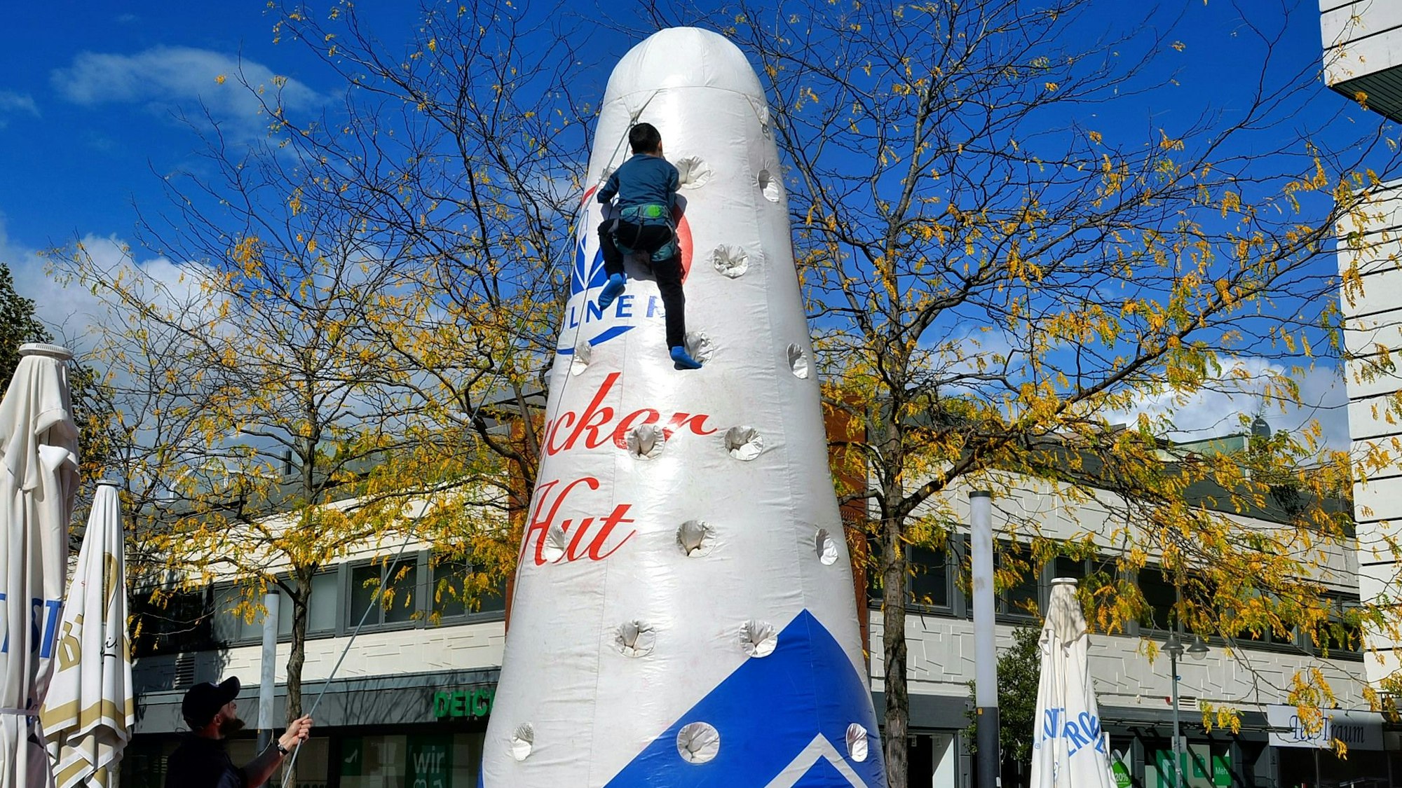 Das Bild zeigt einen Jungen, der gesichert einen Zuckerhut hochklettert. Der ist aber mit Luft gefüllt und nicht aus Zucker.