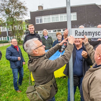 Gemeinsam befestigen Bürgermeister Georg Ludwig (l.) und sein ukrainischer Amtskollege Volodymyr Teterkyi das neue Straßenschild.