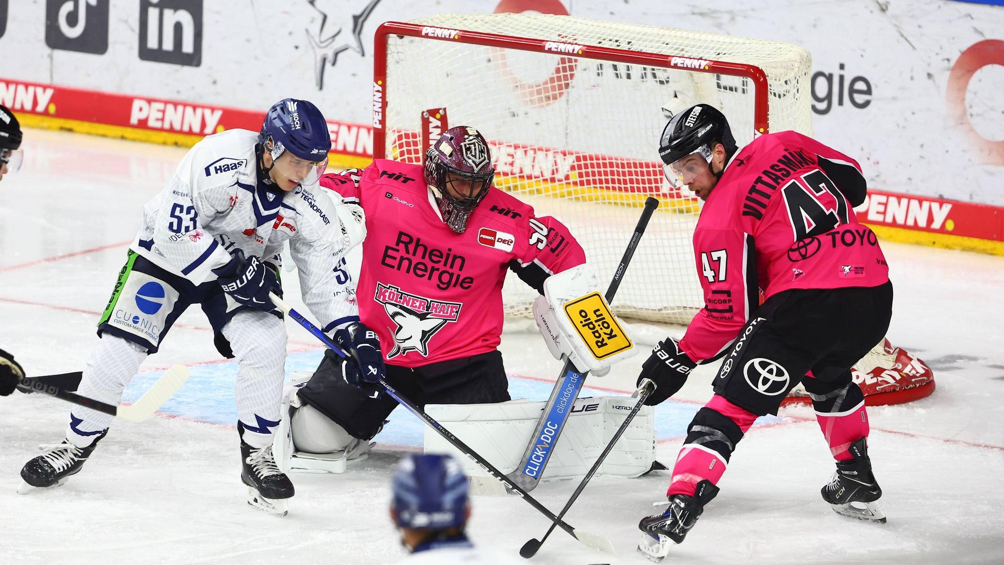 Danjo Leonhardt (l., Straubing) am Donnerstag (3. Oktober) im Zweikampf mit Veli-Matti Vittasmäki vor dem Tor von Julius Hudacek (Kölner Haie).