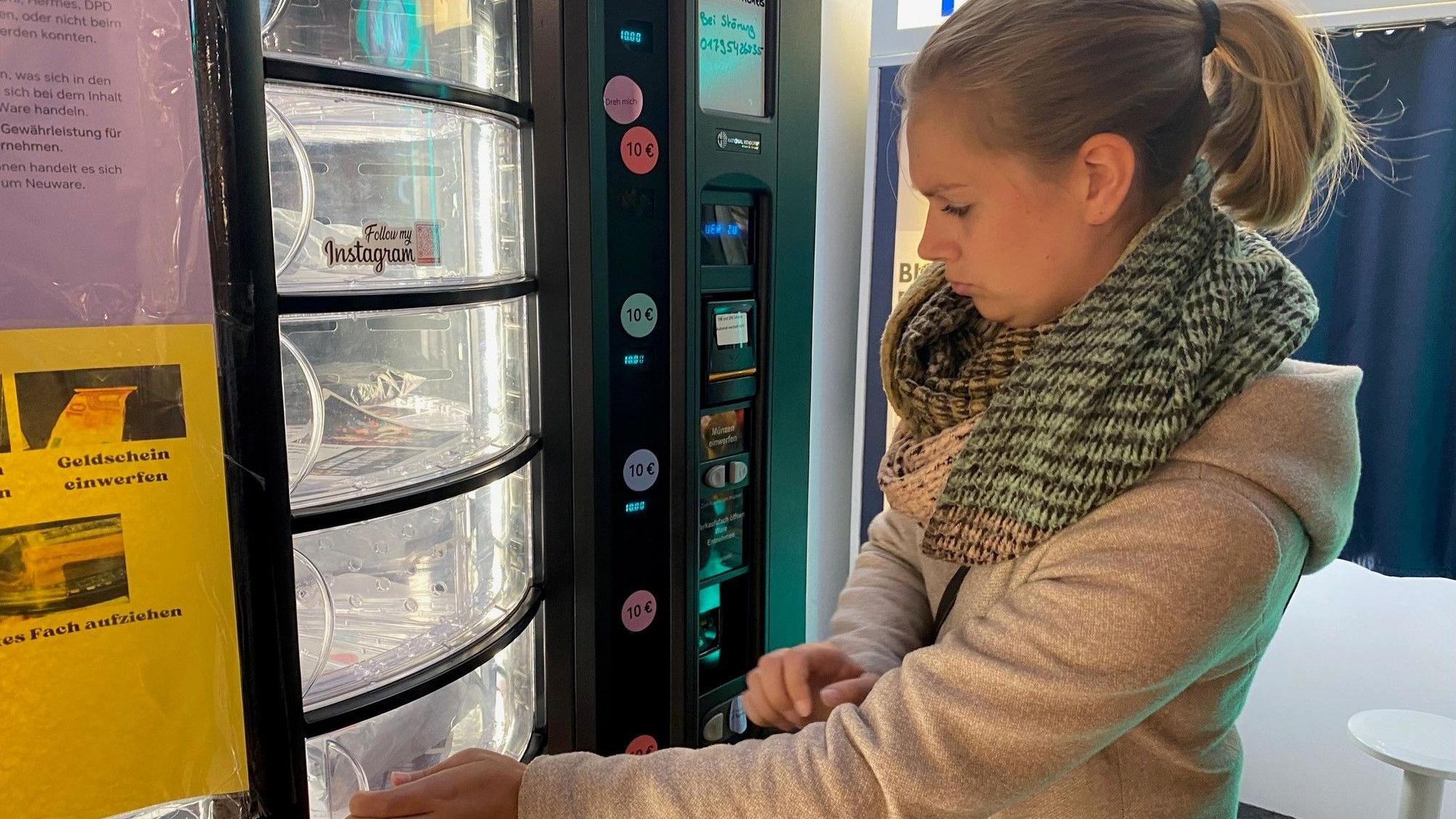 Zu sehen ist Mareike Thelen, die den Automaten bedient.