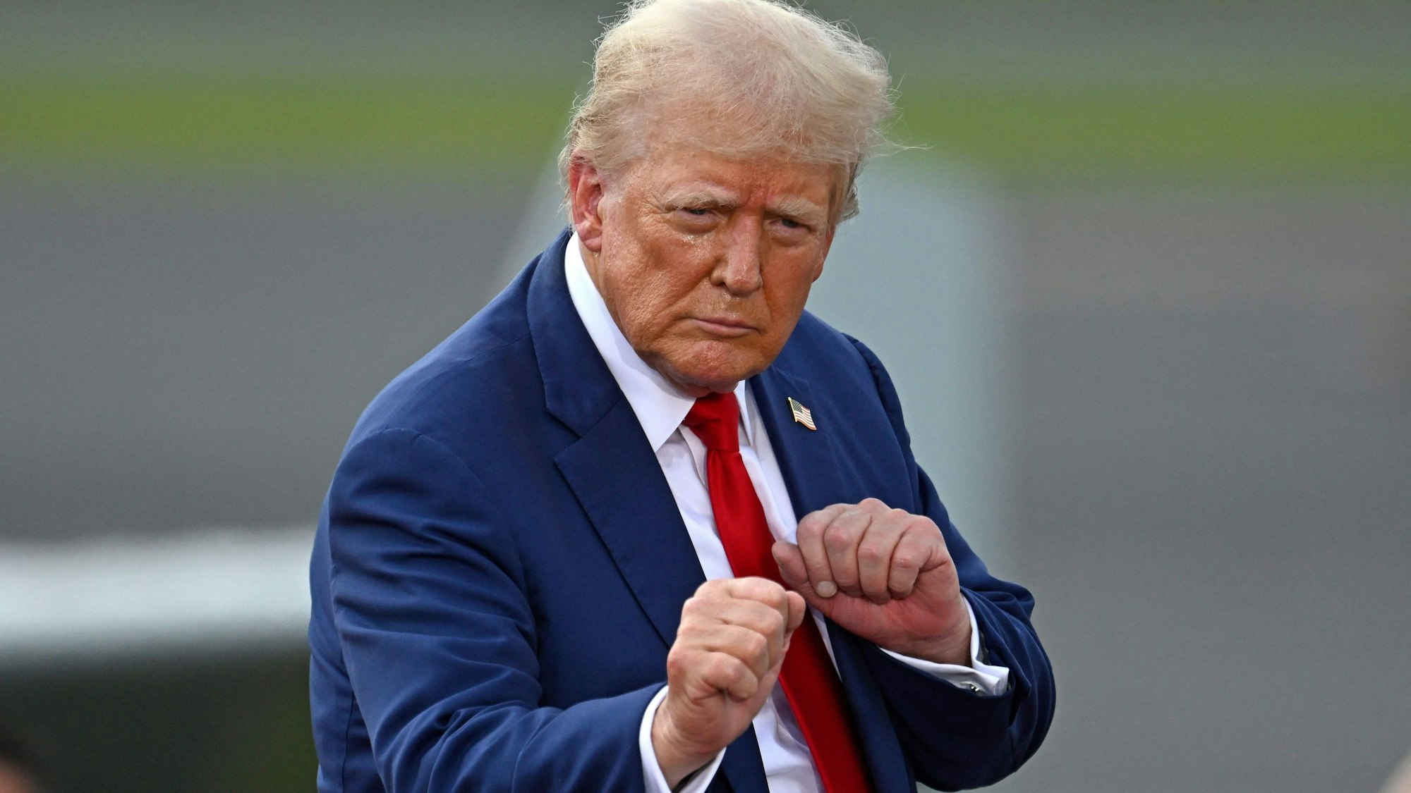 (FILES) Former US President and Republican presidential candidate Donald Trump gestures during a campaign rally at the North Carolina Aviation Museum & Hall of Fame in Asheboro, North Carolina, August 21, 2024. Kamala Harris and Donald Trump are entering the final one-month sprint to the most dramatic US presidential election in modern history, with both candidates warning the fate of a divided nation hangs on a result that is still too close to call. (Photo by Peter Zay / AFP)
