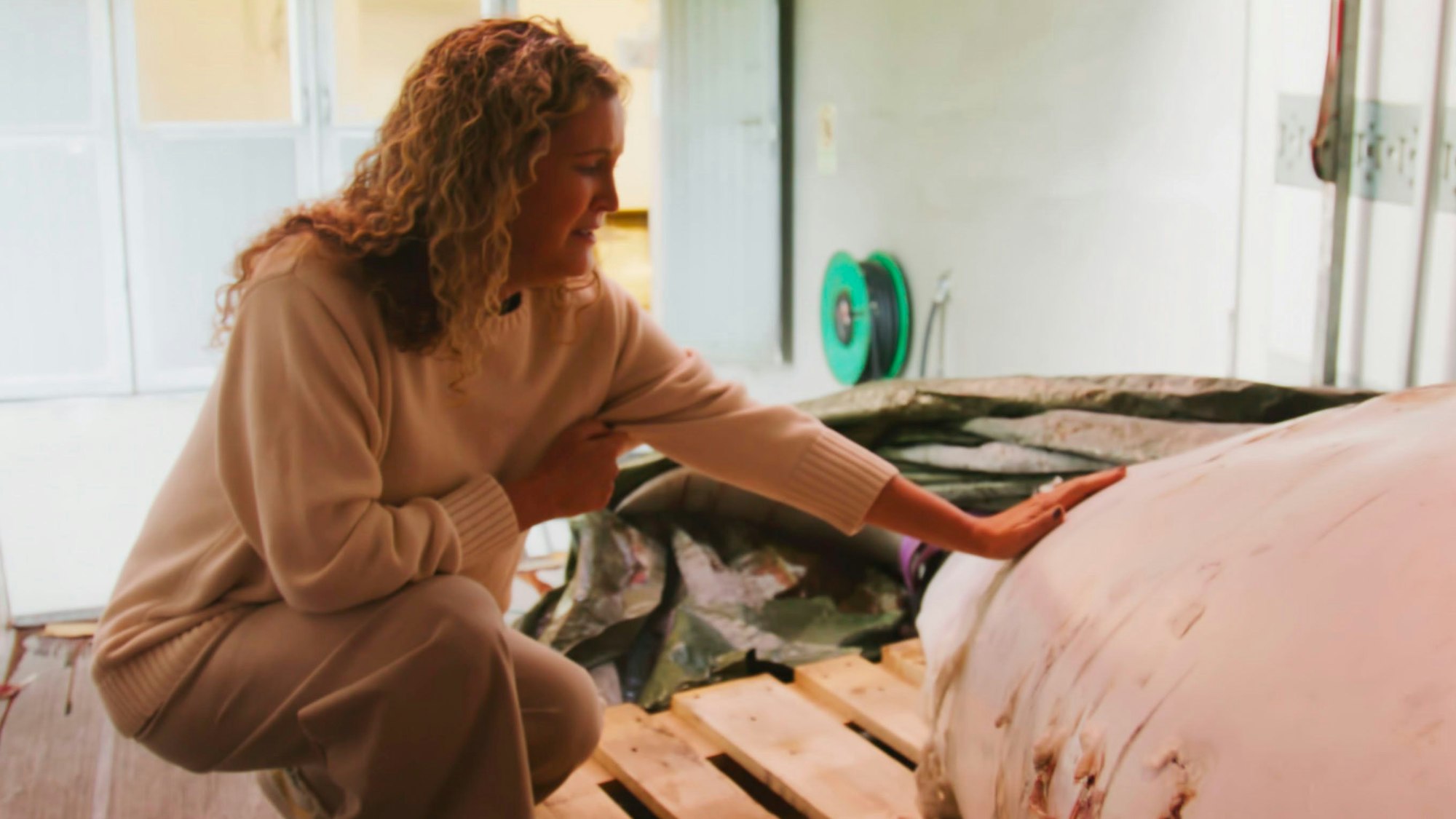 Managerin Regina Haug von OneWhale hockt neben dem Kadaver des Belugawals „Hvaldimir“.