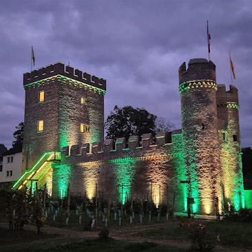 Das historische Weiertor ist in den Farben Gelb und Grün angeleuchtet, den Vereinsfarben der Hovener Jungkarnevalisten.