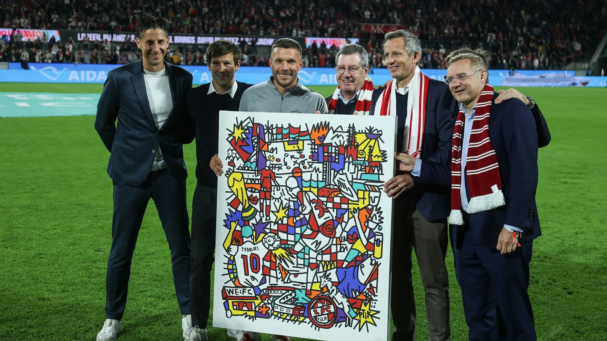 Fussball, 2.Bundesliga Saison 2024/2025 Unsere 10 FC-Vorstand und Geschäftsführung überreichen Lukas jetzt eine Illustration des jungen Kölner Künstlers Jakob Schwald.