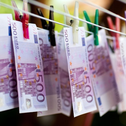 An einem Wäscheständer hängen mit Klammern befestigt Geldscheine