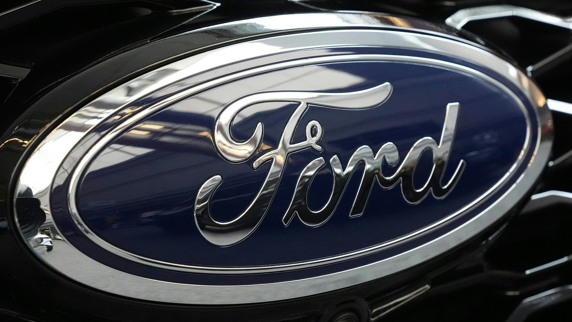FILE - The Ford logo is seen on the grill of a Ford Explorer on display at the Pittsburgh International Auto Show in Pittsburgh, on Feb. 15, 2024. (AP Photo/Gene J. Puskar, File)